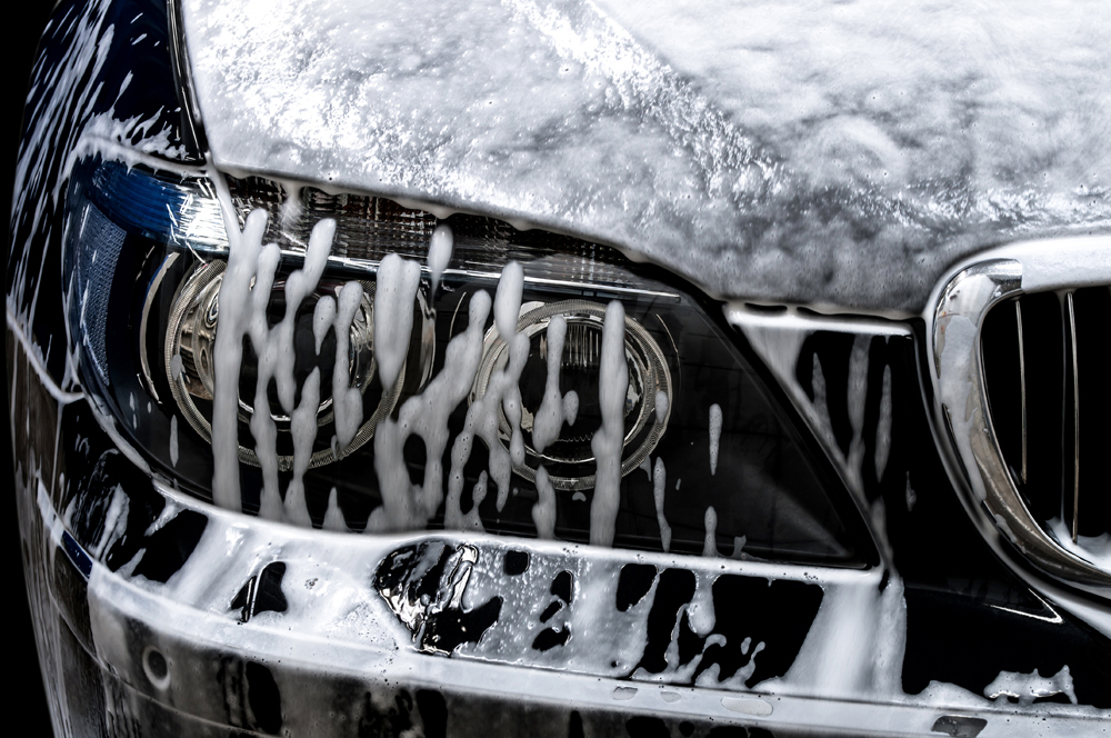 front end of a vehicle covered in soap suds